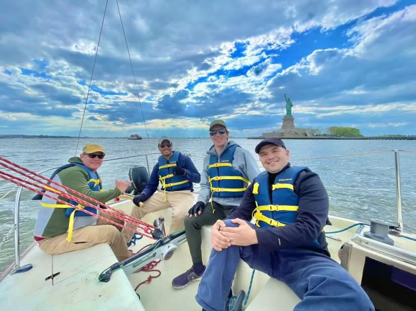 sailors having fun in front of statue